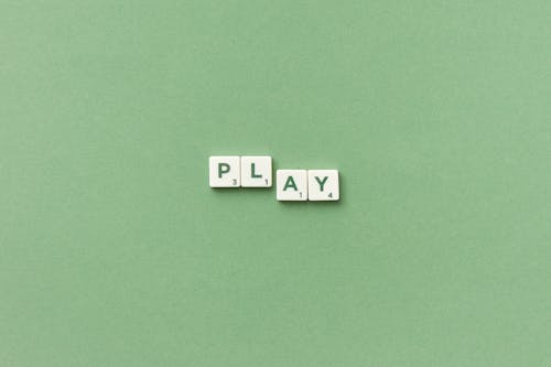 White Scrabble Tiles with Green Letters