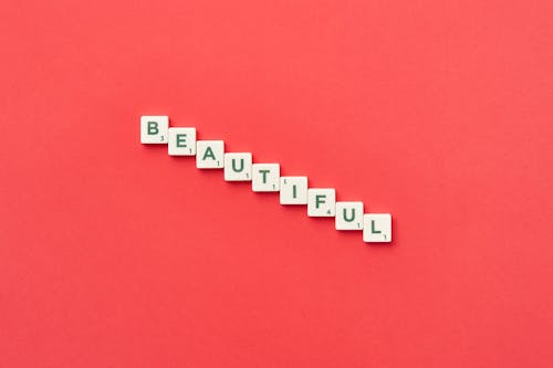 Free White Scrabble Pieces on Red Surface Stock Photo