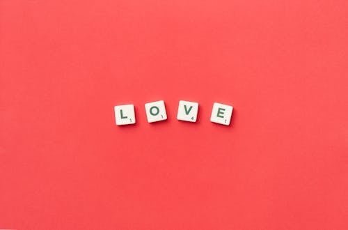 Love Spelled with Scrabble Tiles on a Red Background