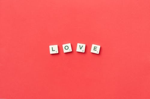 Love Spelled with Scrabble Tiles on a Red Background