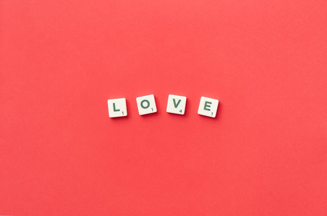 Love Spelled with Scrabble Tiles on a Red Background