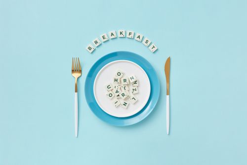Free Stylish breakfast theme with letters on a plate, set against a pastel blue background. Stock Photo