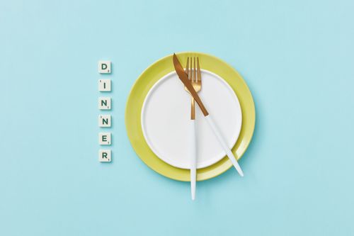 Free Top view of dinner set with Scrabble tiles on blue background, artistic flat lay. Stock Photo