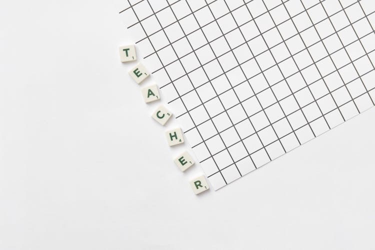 Teacher Text And Grid On White Background