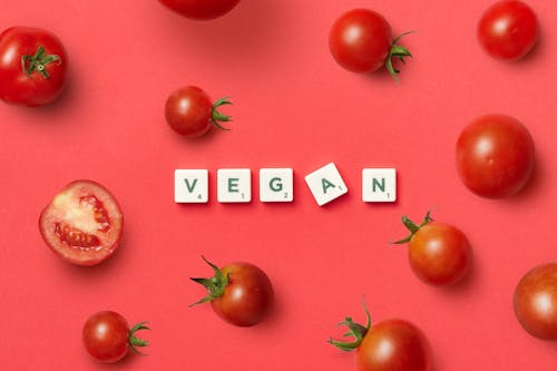Letters Spelling the Word Vegan and Tomatoes Around Them