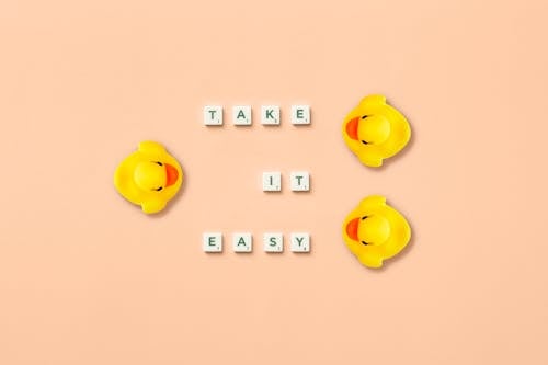 A Phrase Spelled with Scrabble Tiles and Rubber Ducks