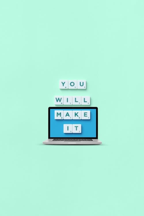 Phrase and Laptop on Green Background
