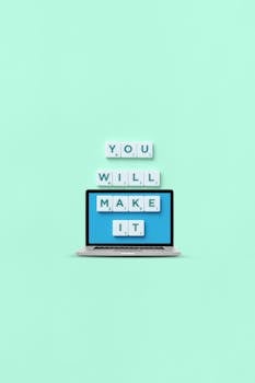 A minimalist design featuring a laptop displaying an uplifting motivational message on a green background.