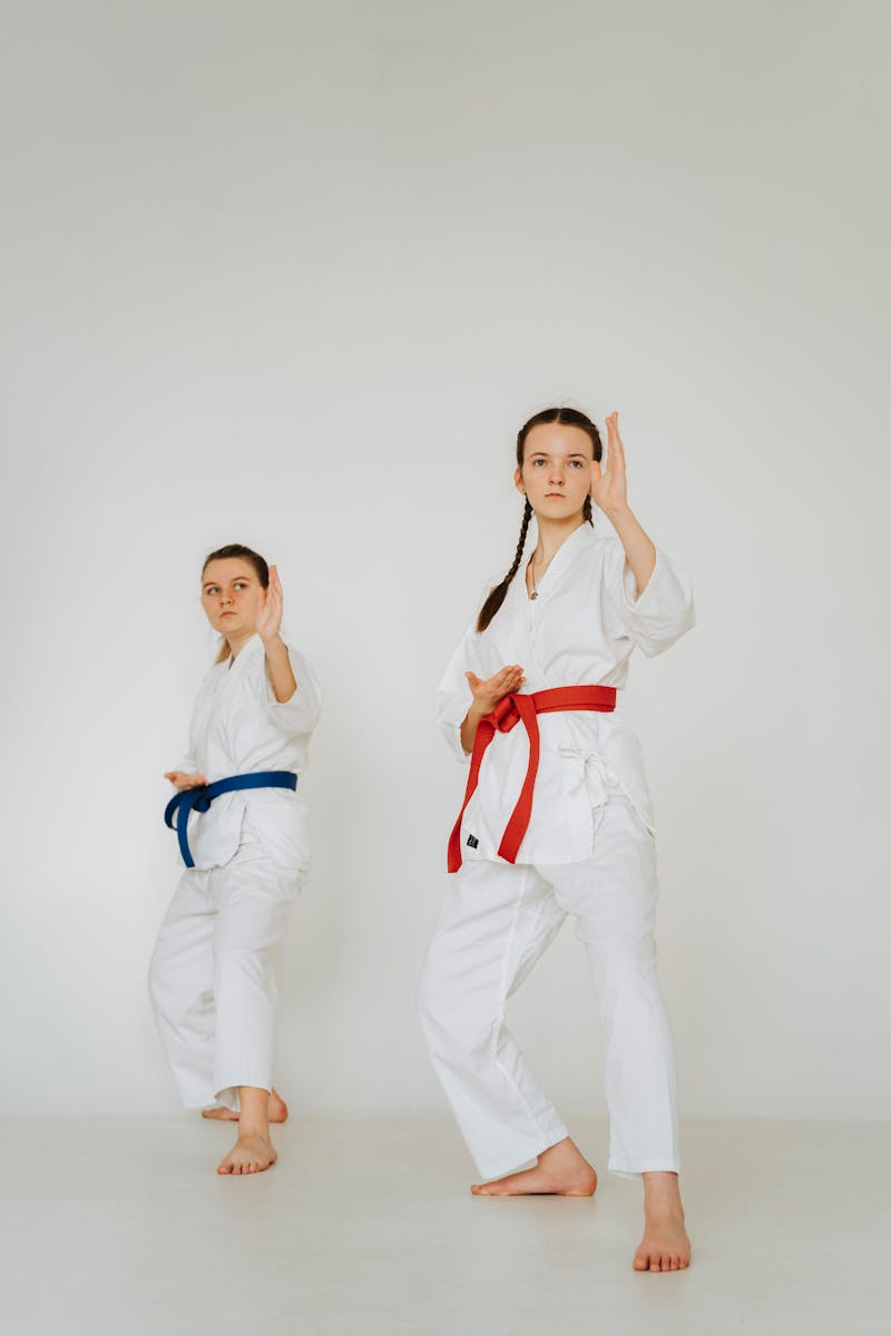 Two martial arts practitioners sparring during self-defense training session