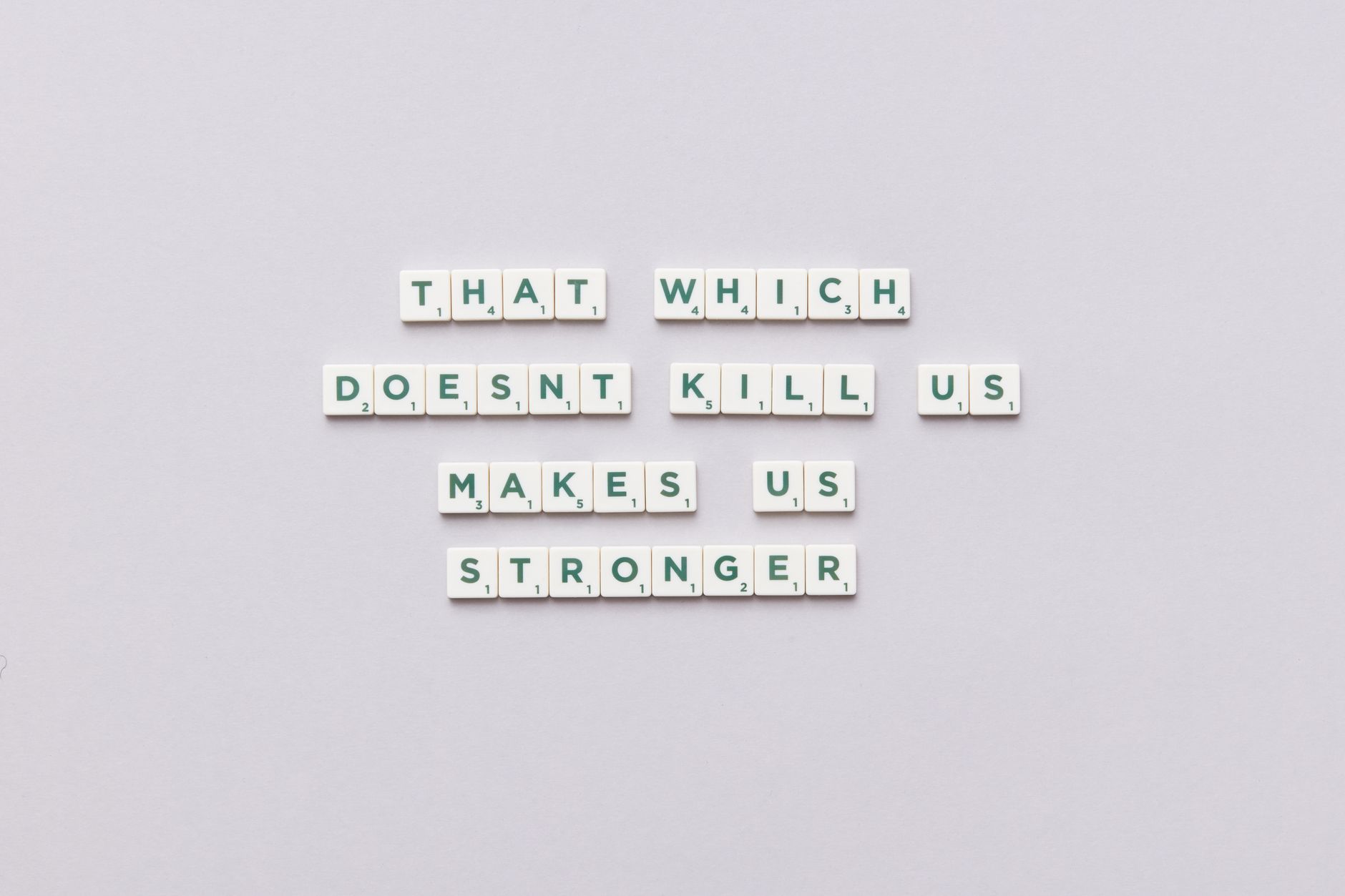 Inspirational quote using Scrabble tiles on a light background, perfect for motivational content.