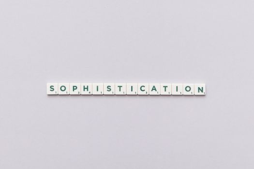 Letter tiles spelling out 'Sophistication' on a neutral background, perfect for conceptual themes.