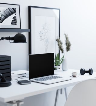 Sleek home office setup featuring a laptop, modern decor, and minimalistic design elements.