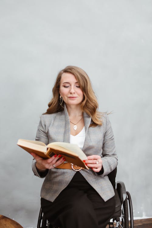 Woman in Gray Blazer Reading a Book