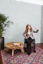 Woman in Gray Blazer Sitting on Brown Wooden Seat