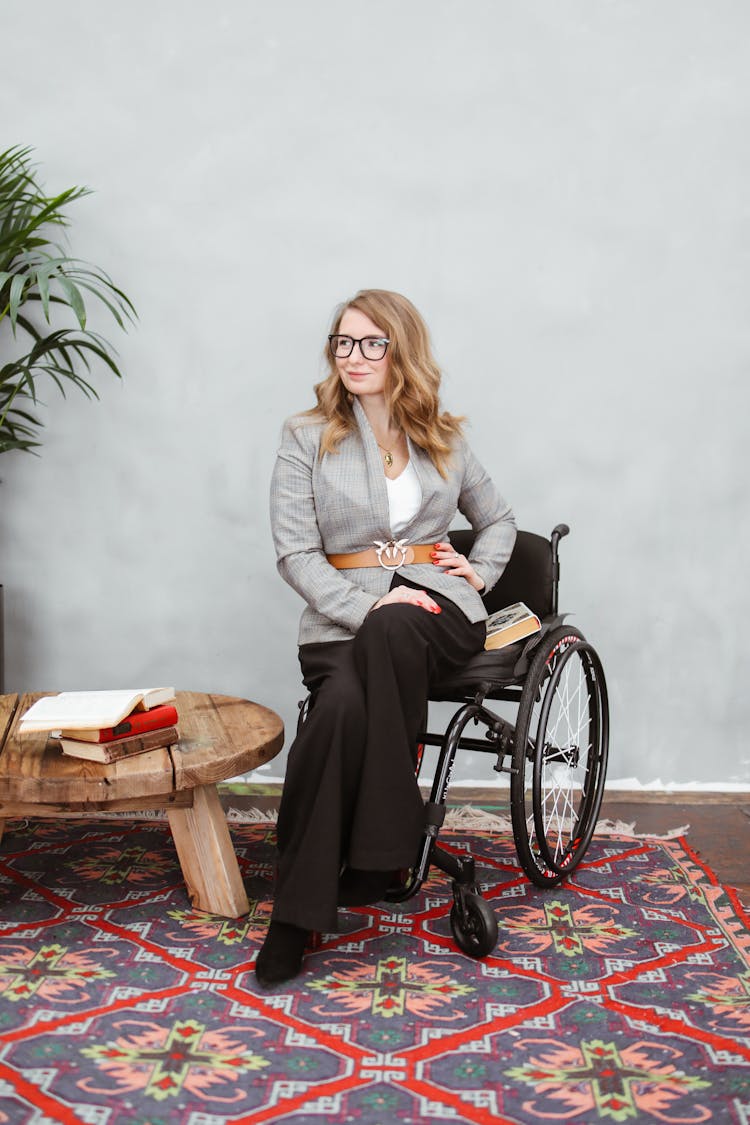 Woman In Plaid Blazer Sitting On A Black Wheelchair