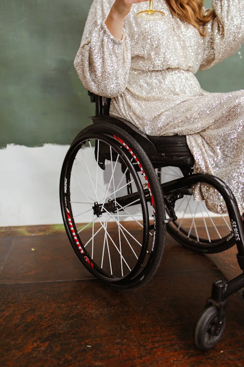 Person Wearing Sequin Dress Sitting on Black Wheelchair