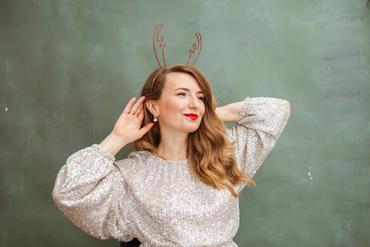 Woman Smiling Wearing A Reindeer Headband