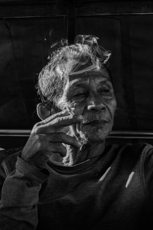 Free Elderly Man Holding a Cigarette Stock Photo