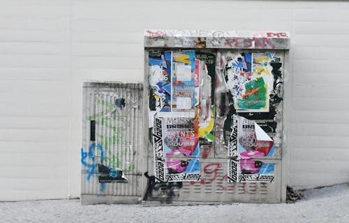 Silver Garbage Containers with Graffiti and Posted Posters