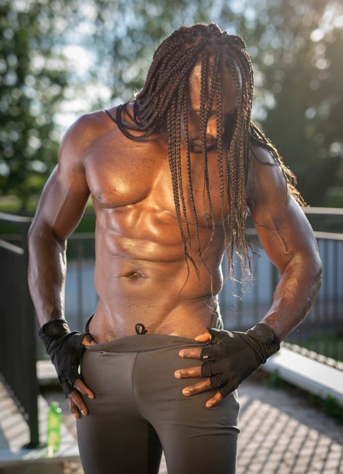Free An athletic man with braided hair focuses on his fitness outdoors in Madrid, Spain. Stock Photo