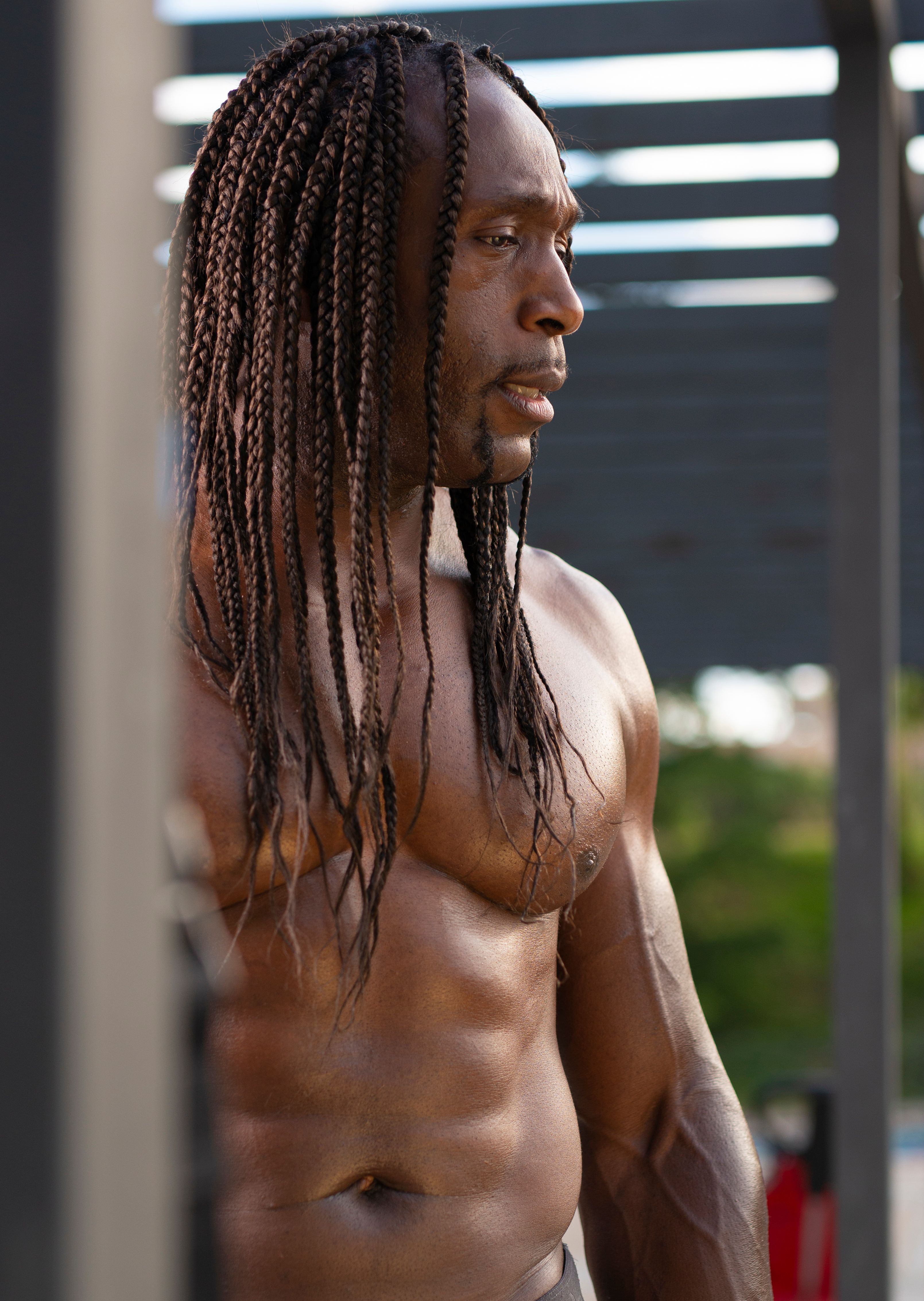 A fit man showcasing his physique outdoors, highlighting a focused fitness lifestyle.
