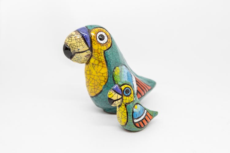 Colorful Ceramic Bird Figurines On White Background 