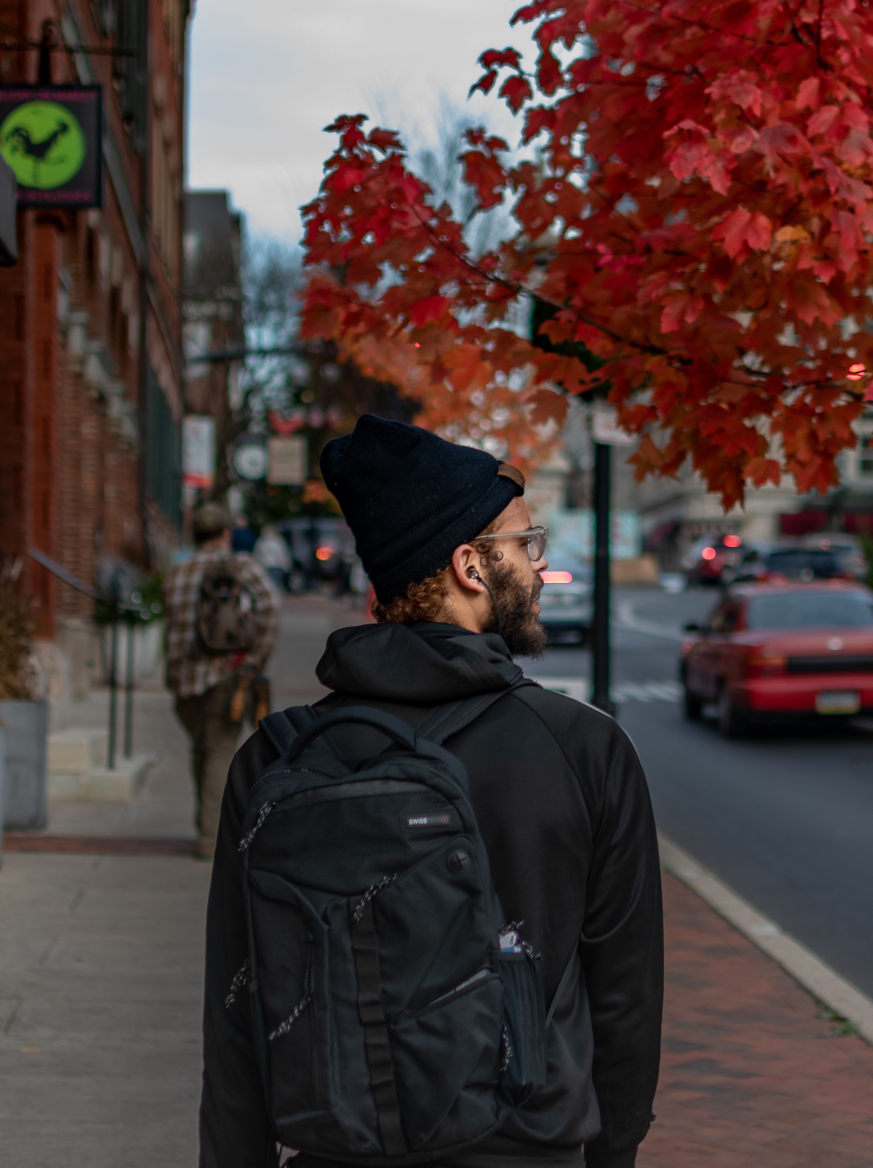 A Man in Black Hoodie Standing on the Street while Looking Over ...