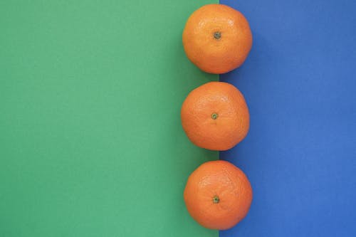 Orange Fruits on Green and Blue Background 