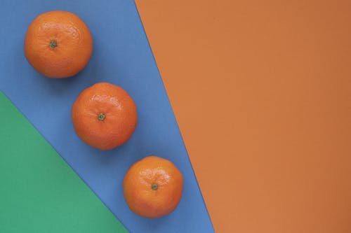 Orange Fruits on Blue Colored Paper 