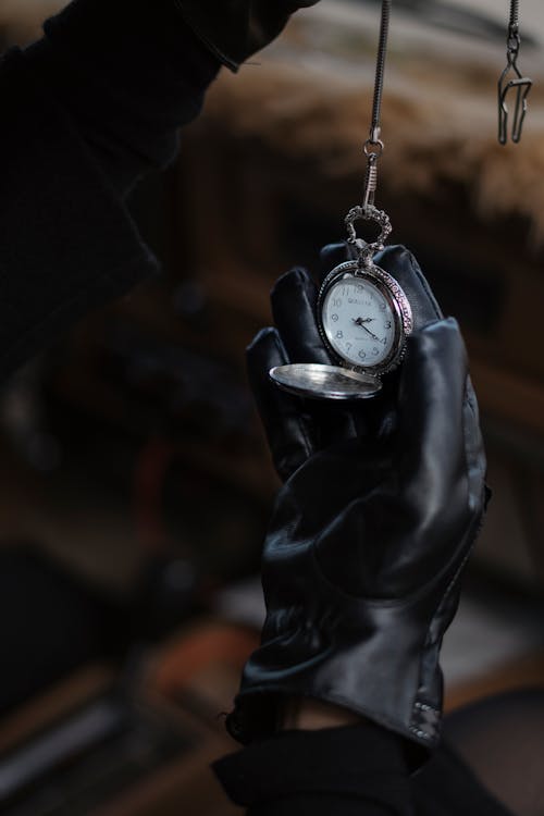 Free Man in leather gloves showing vintage pocket watch Stock Photo