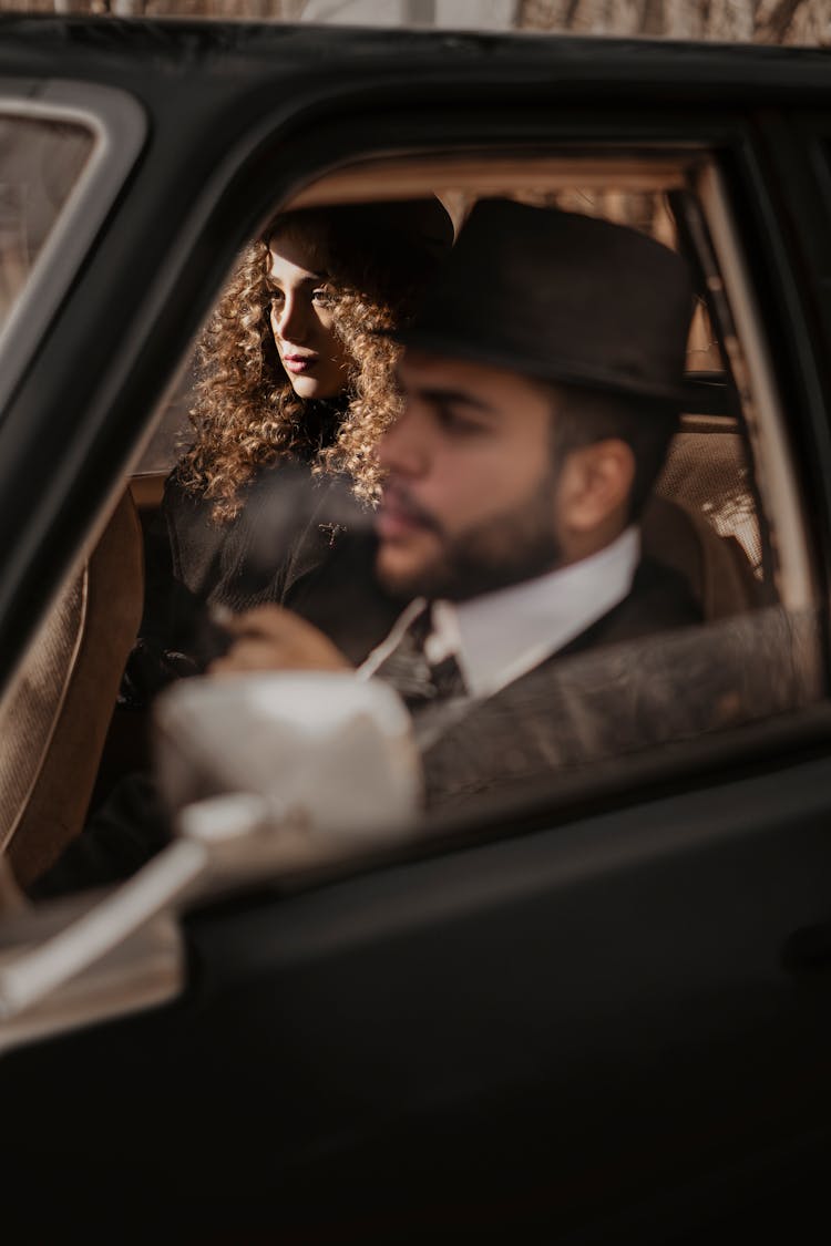 Diverse Serious Couple Travelling In Car