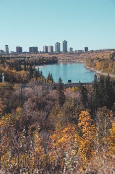 Beautiful autumn cityscape with a scenic lake and vibrant foliage.