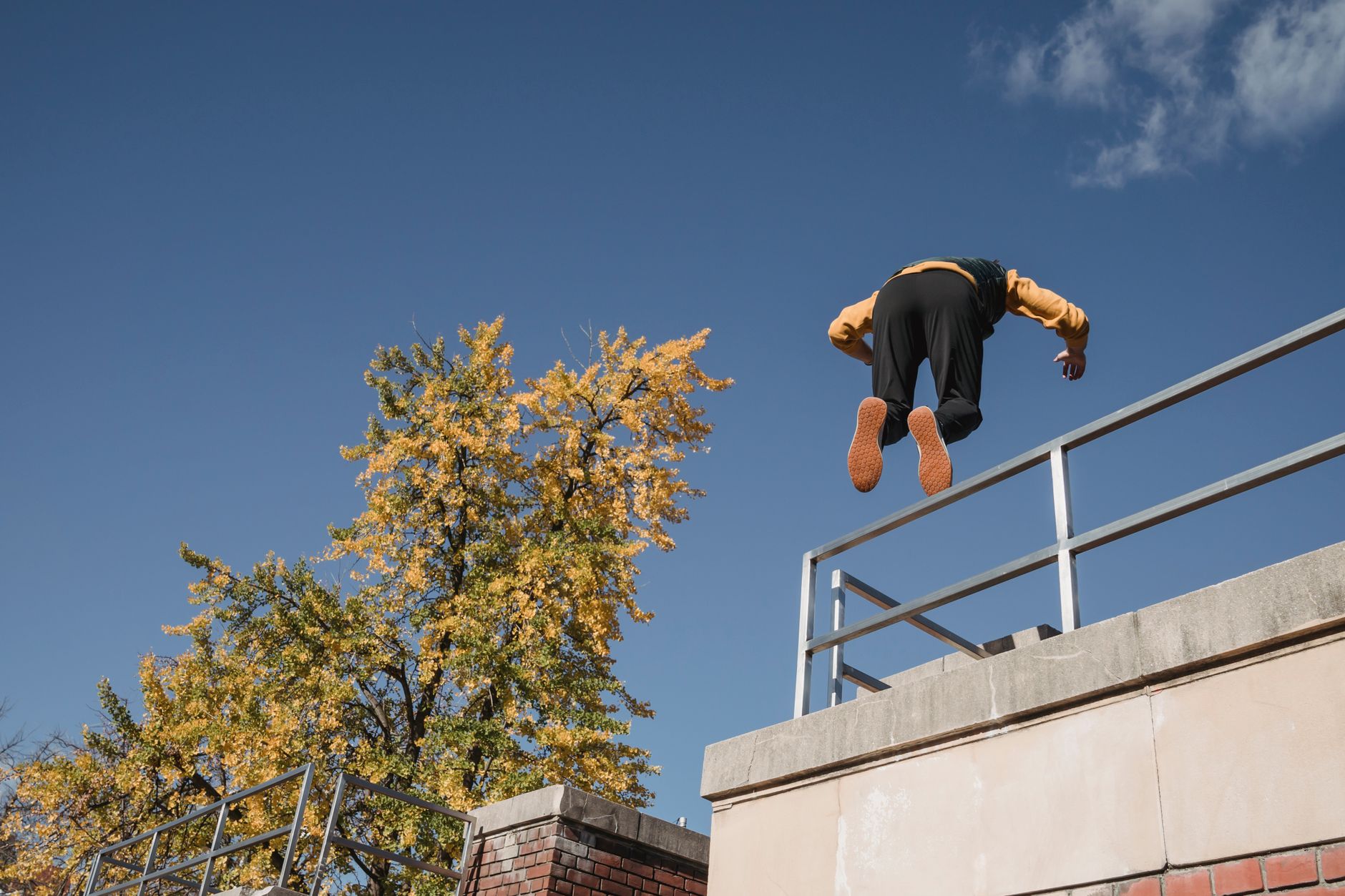Strong Man Performing Parkour On Roof Free Stock Photo strong-man-performing-parkour-on-roof-free-stock-photo