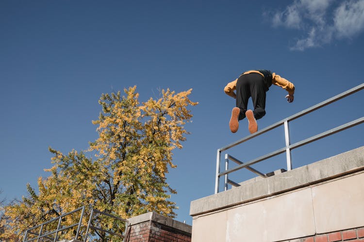 Strong Man Performing Parkour On Roof