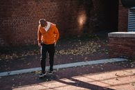Faceless man standing on street near at road drain