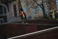 Man walking on brick building parapet