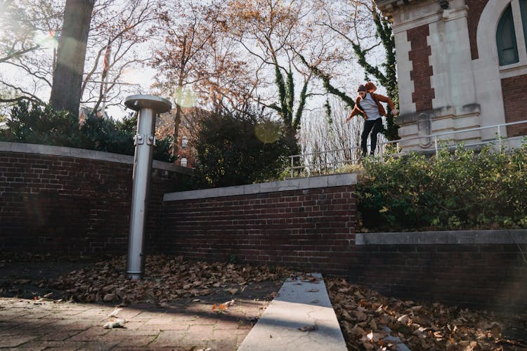 Brave Man Jumping Over Obstacle In Park