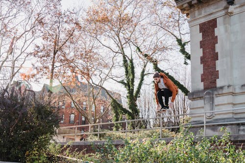 Man jumping over railing in city district