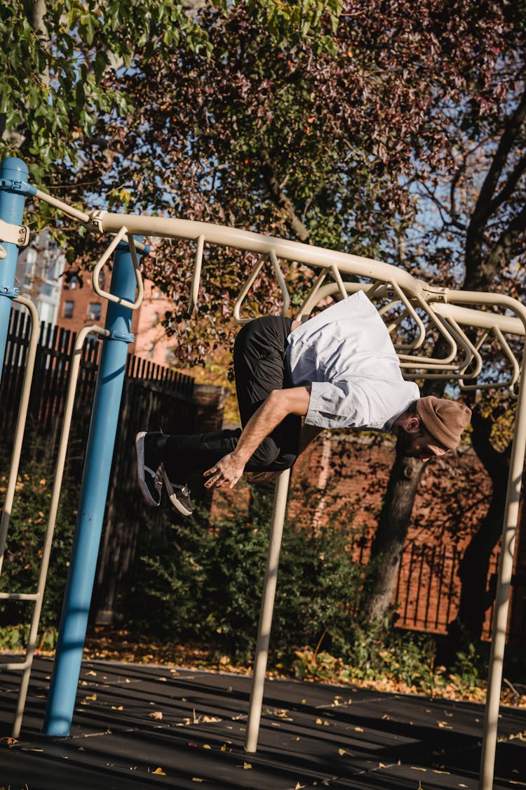 Man Doing Backflip Near Turnstile In Park In Town