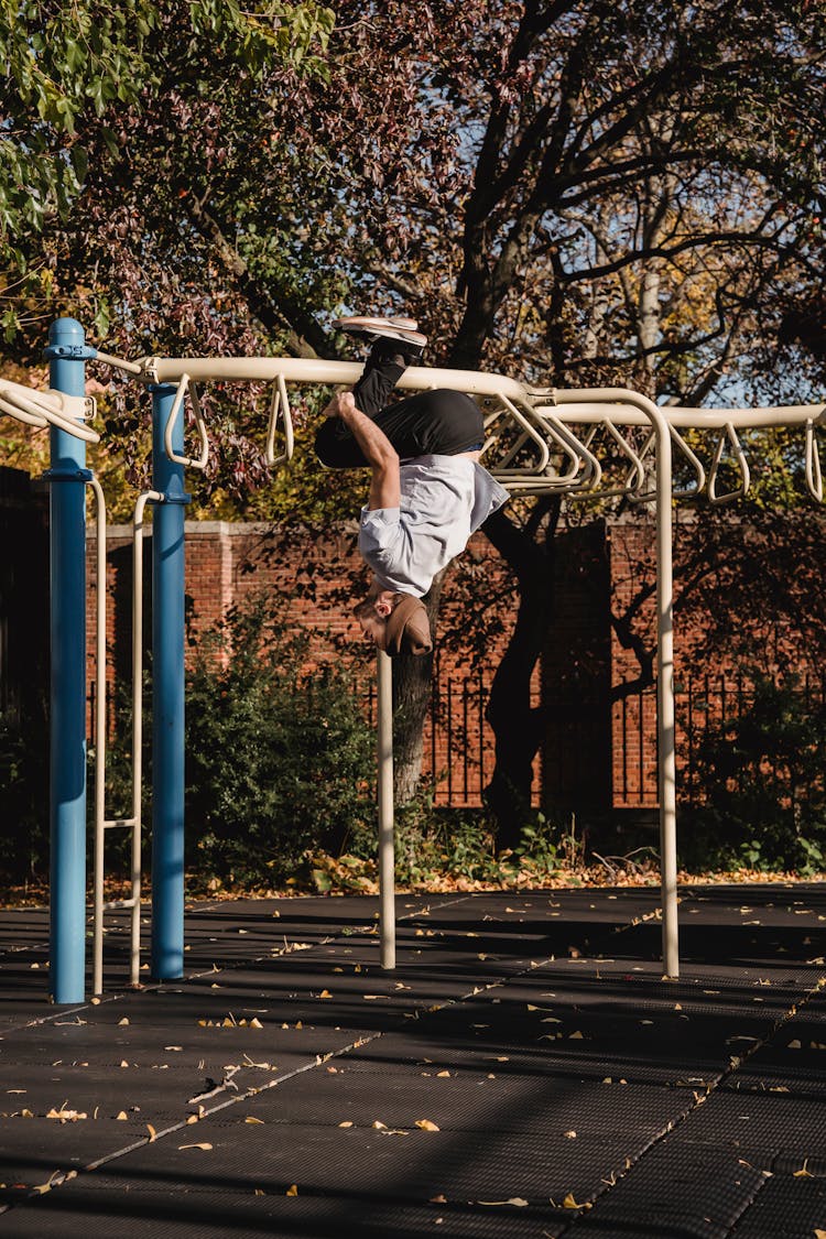 Man Doing Backflip While Parkour In City In Park