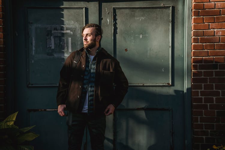 Guy Standing Near Building Door In City Street