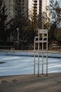 Metal chair at empty pool on sport ground