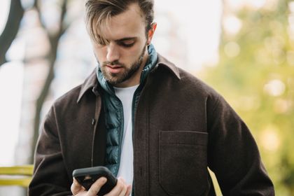 Man in a park with a phone