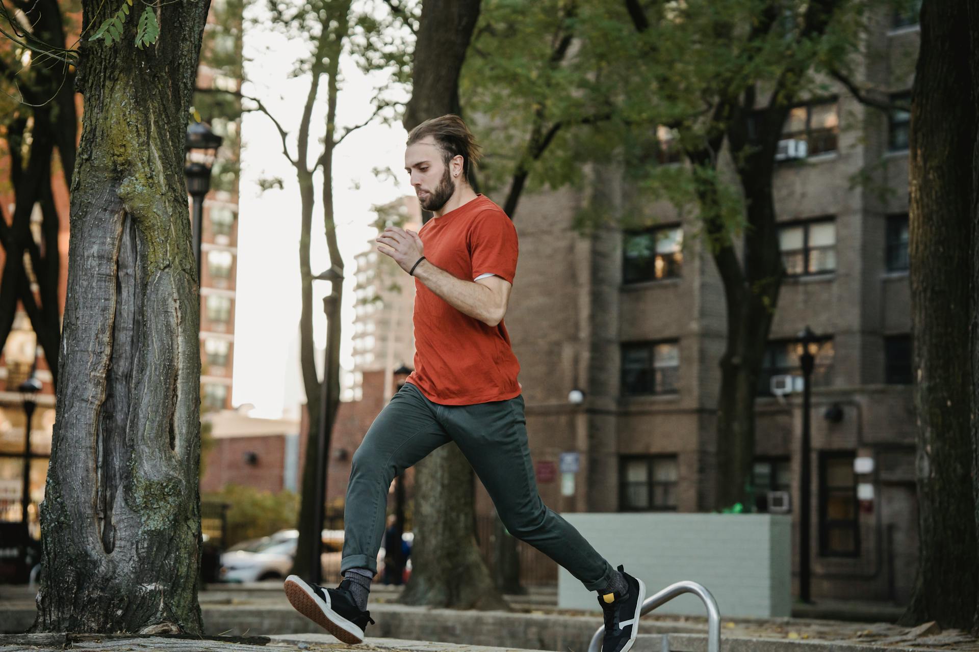 Bearded sportsman running on urban stairs during training