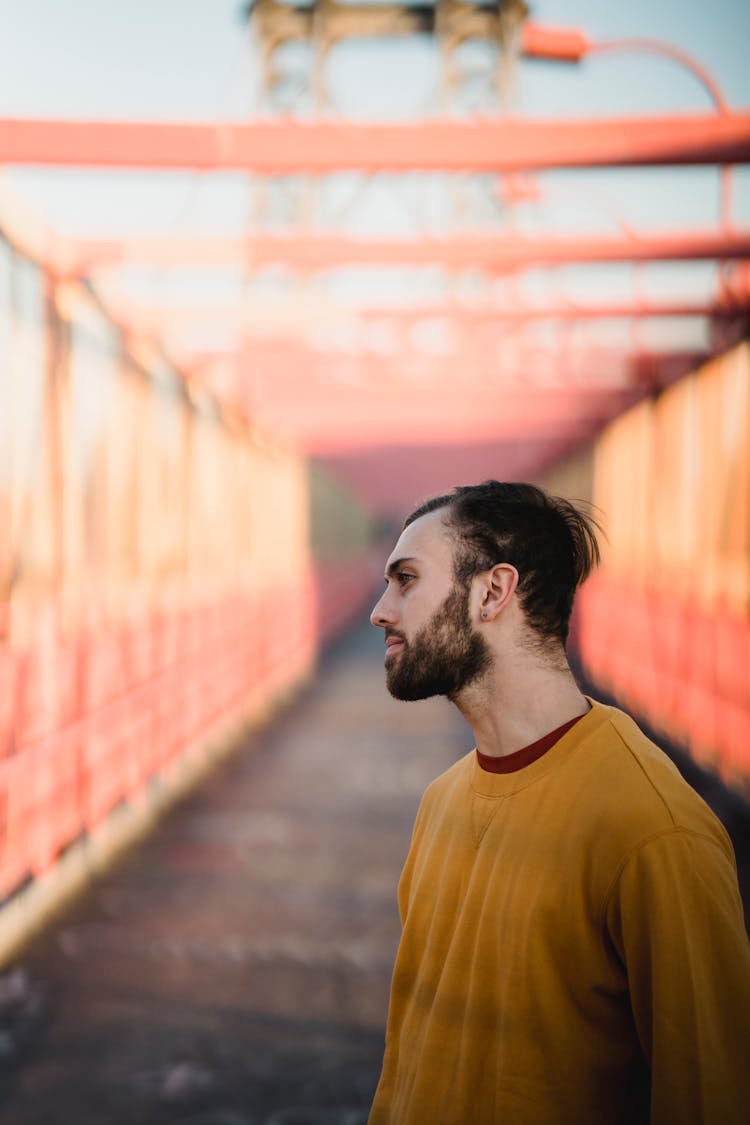 Unshaven Man In Casual Apparel On Urban Bridge