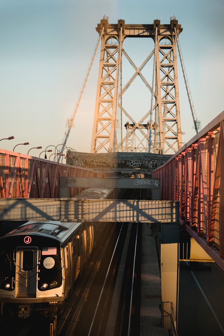 Train On Railroad Of Urban Bridge In Sunlight