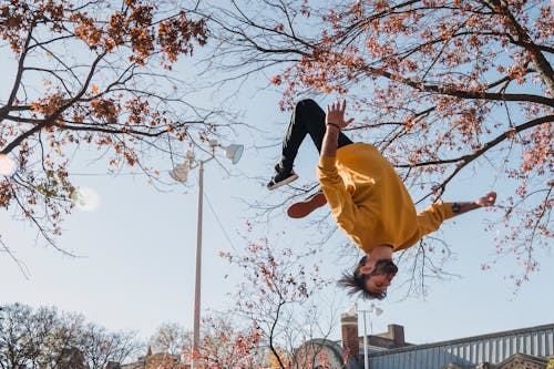 Free Flexible man doing flip on street Stock Photo