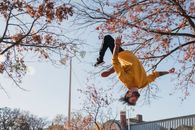 Flexible man doing flip on street