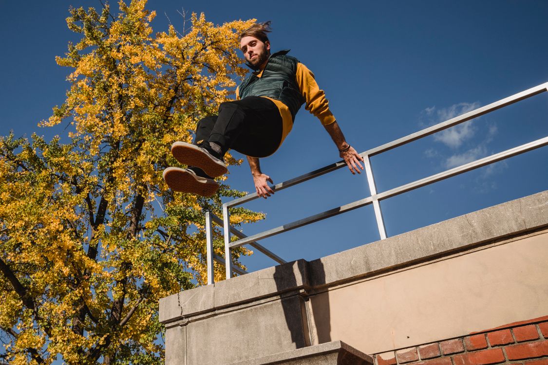 Sportsman jumping off metal railing · Free Stock Photo