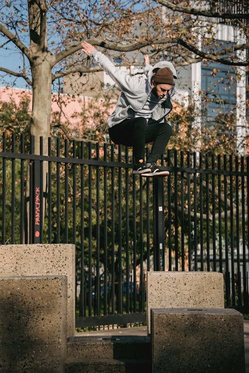 Active man jumping on stone border